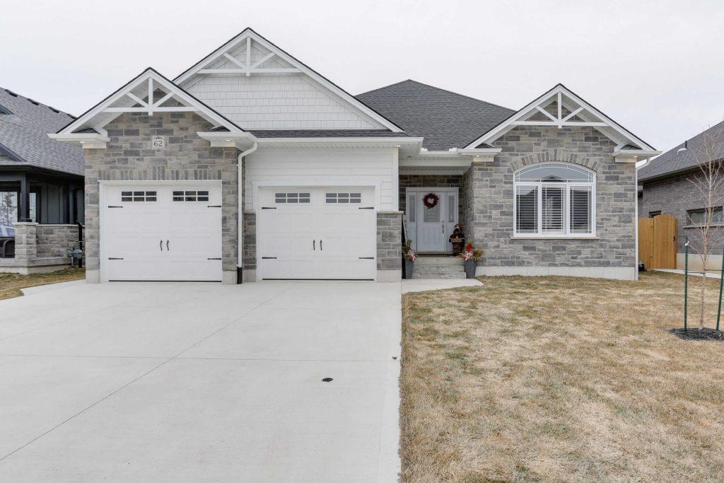 Beautiful brick house exterior showing a double garage and front yard.